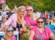 Group of women in pink at Music in the Park, Leyland